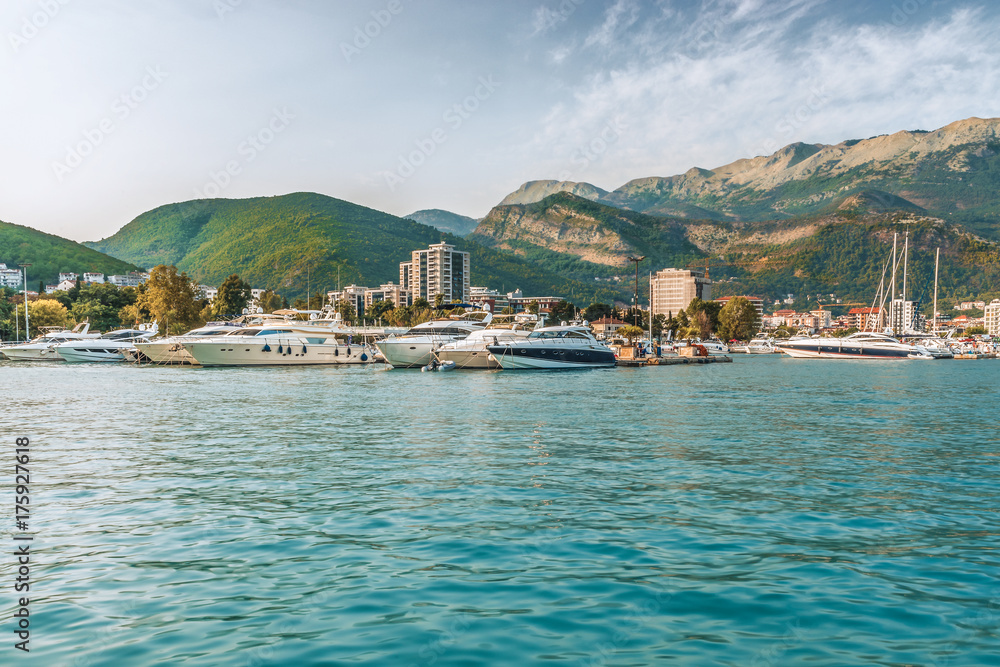  Pier for sailing yachts and boats with a view of the mountains off the coast of Budva, Montenegro.