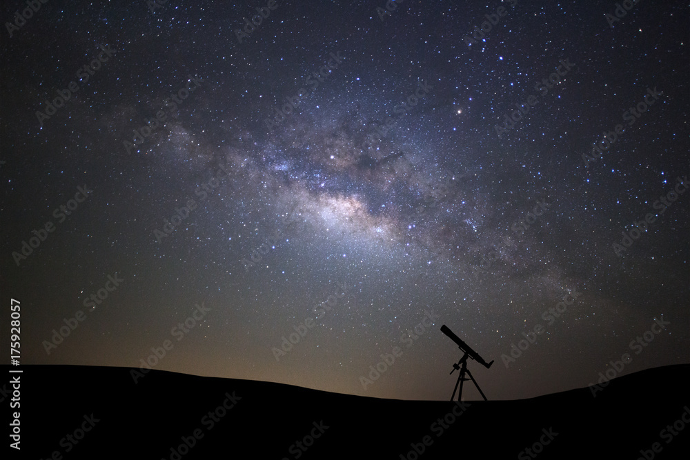 Silhouette of telescope watching the wilky way galaxy with stars and space dust in the universe