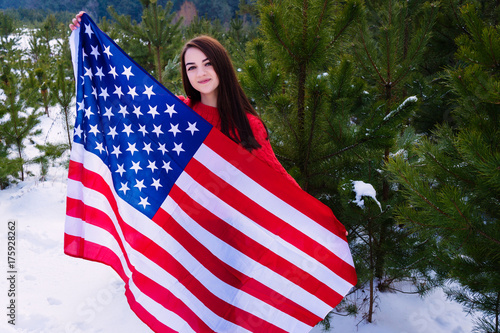 The girl holds the flag of the USA.