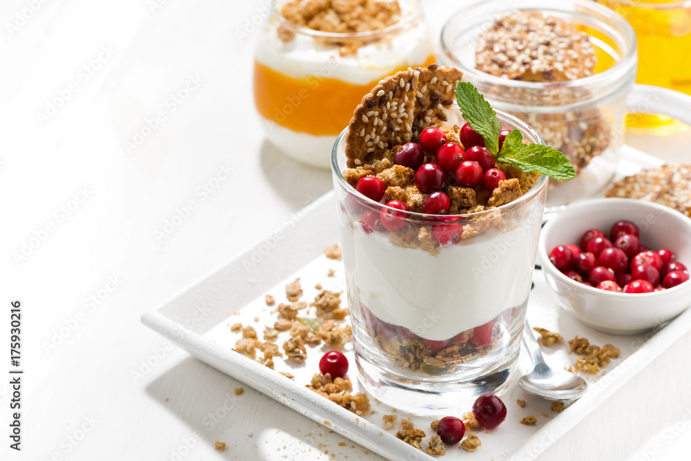 dessert with granola, cranberries and cream on tray dessert with granola, cranberries and cream on tray