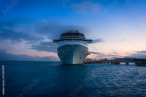 Water level view of cruise ship bow, docked at sunset, bermuda
