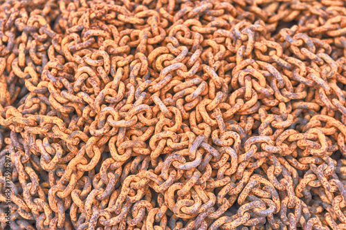 Mountain of rusty iron chain. Orange background © Annashou