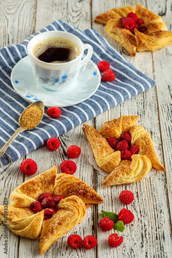 Tasty fresh homemade puff pastry with berries on the white wooden table Tasty fresh homemade puff pastry with berries on the white wooden table
