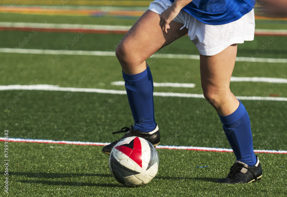 Soccer player controlling the ball during a game Soccer player controlling the ball during a game