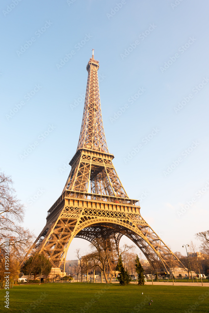 Eiffel tower against blue sky at sunrise in Paris - France