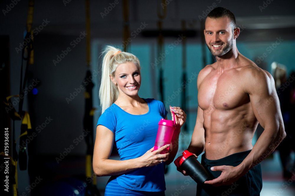 man and woman with protein shake at gym man and woman with protein shake at gym