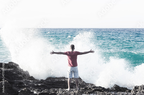 Man in front of big wave