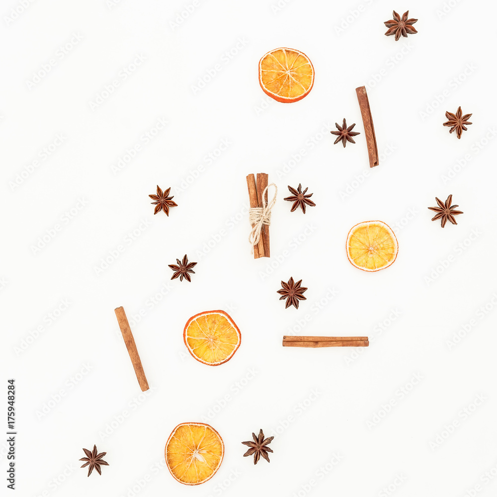 Cinnamon, badian and dried oranges isolated on white background. Christmas or New Year concept. Flat lay, top view. Cinnamon, badian and dried oranges isolated on white background. Christmas or New Year concept. Flat lay, top view.