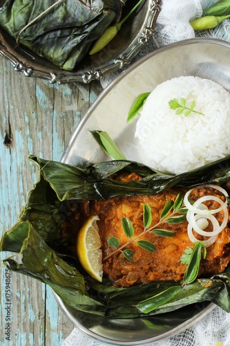 Spicy fish wrappped in banana leaf / Kerala Meen Pollichathu photo