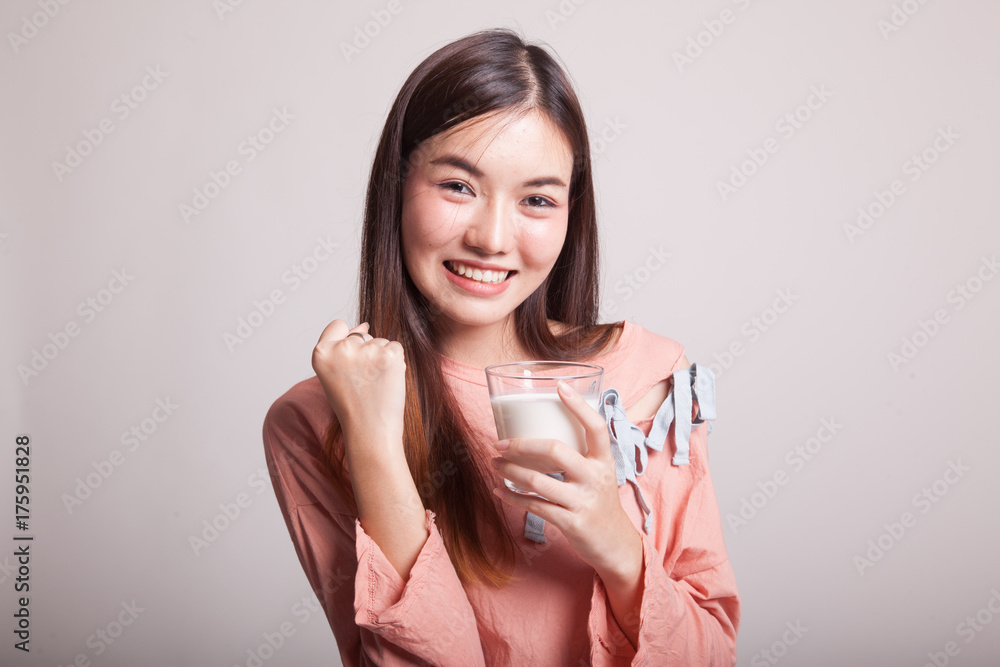 Healthy Asian woman drinking a glass of milk. Healthy Asian woman drinking a glass of milk.