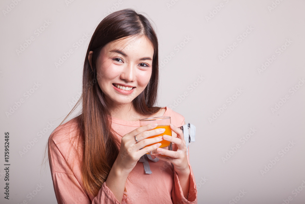 Young Asian woman drink orange juice. Young Asian woman drink orange juice.