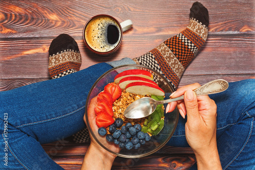 Wallpaper Mural Person having breakfast cross-legged on wooden floor Torontodigital.ca