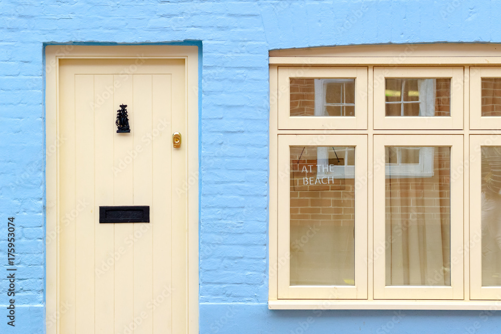 Fototapeta premium Front of an English cottage with a AT THE BEACH sign