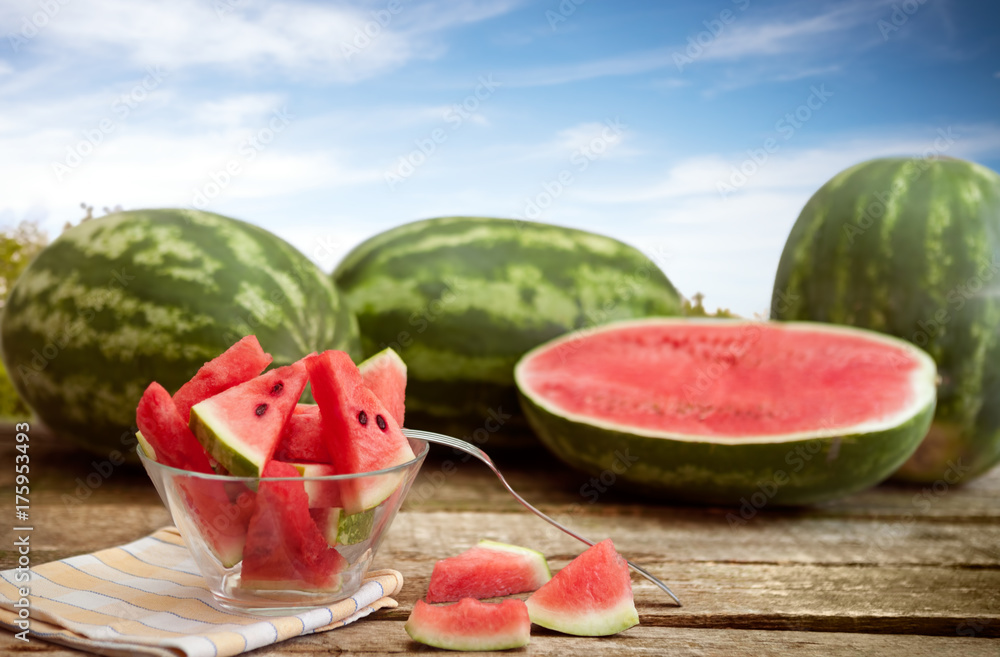 Watermelons on table,watermelons cuts in bowl Watermelons on table,watermelons cuts in bowl