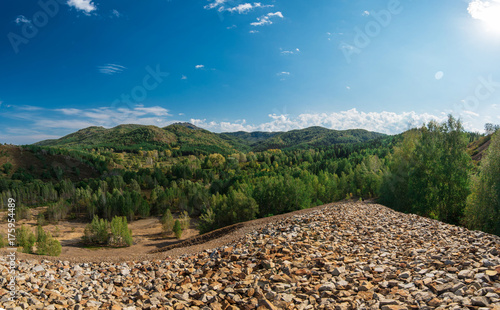 Big mountain from stones, settlement in the Altai Territory. at the foot of Mount Sinyuha, the village was served by a tungsten mine. photo