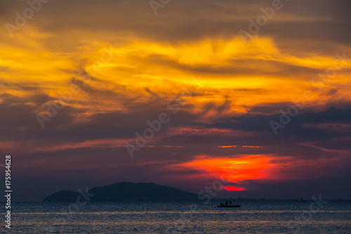 Orange sunset in Sanya, Hainan, China. Colorful madness from the clouds, merging with the sea.