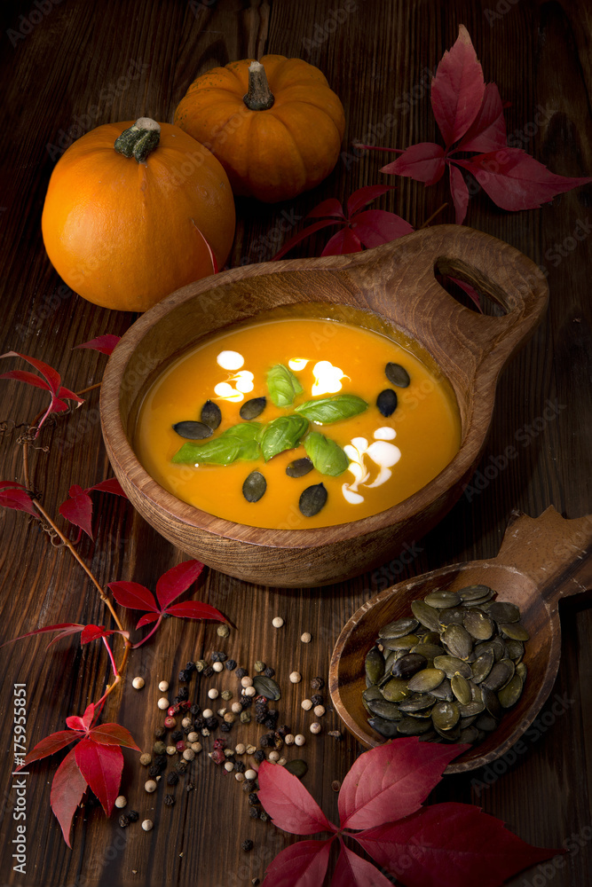 Pumpkin soup food autumn delicious useful basil seeds wooden cup dark background