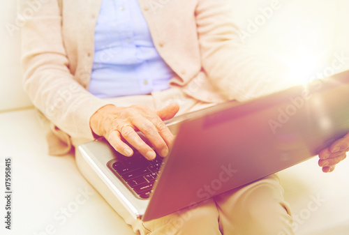 close up of senior woman with laptop at home