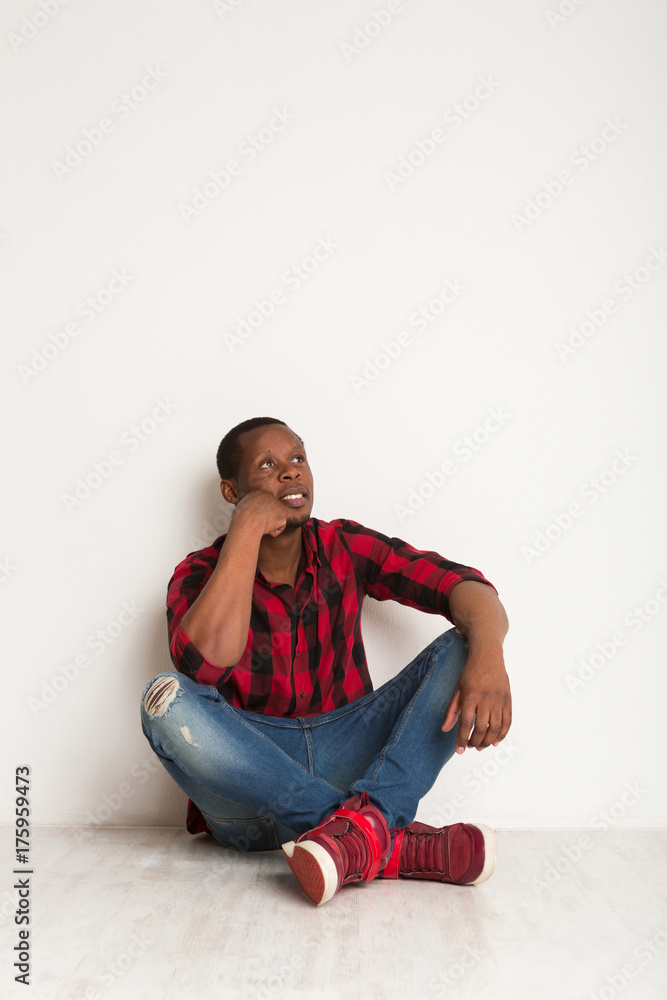 Pensive young black man at studio background Pensive young black man at studio background