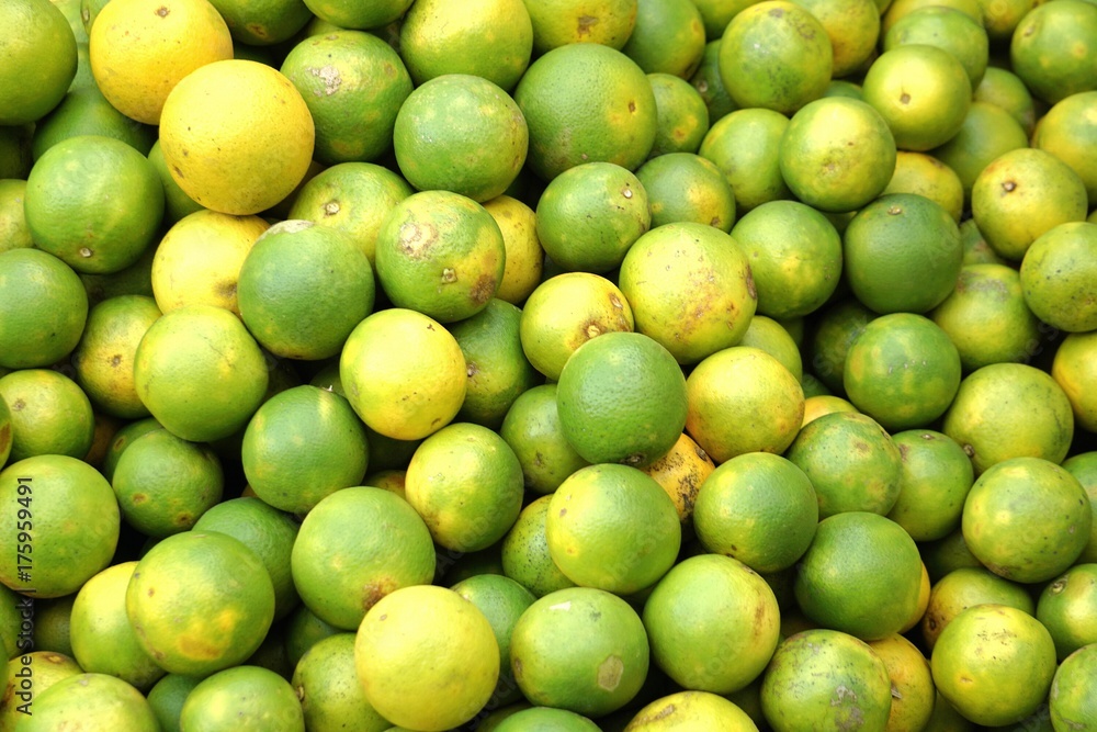 many fresh yellow and green lemon in bazaar