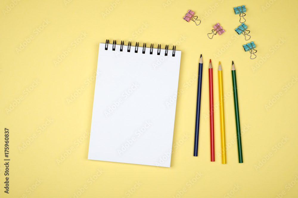 Top view of open spiral blank notebook on colorful desk Top view of open spiral blank notebook on colorful desk