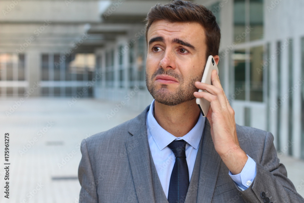 Man getting devastating news on phone call Man getting devastating news on phone call