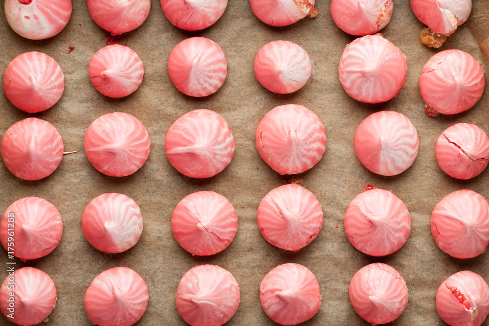 pink meringues arranged at baking paper background top view pink meringues arranged at baking paper background top view