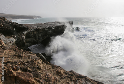 Stormy waves crash against the rocky coast of Atlantic ocean on Fuerteventura island, Canary Islands, Spain