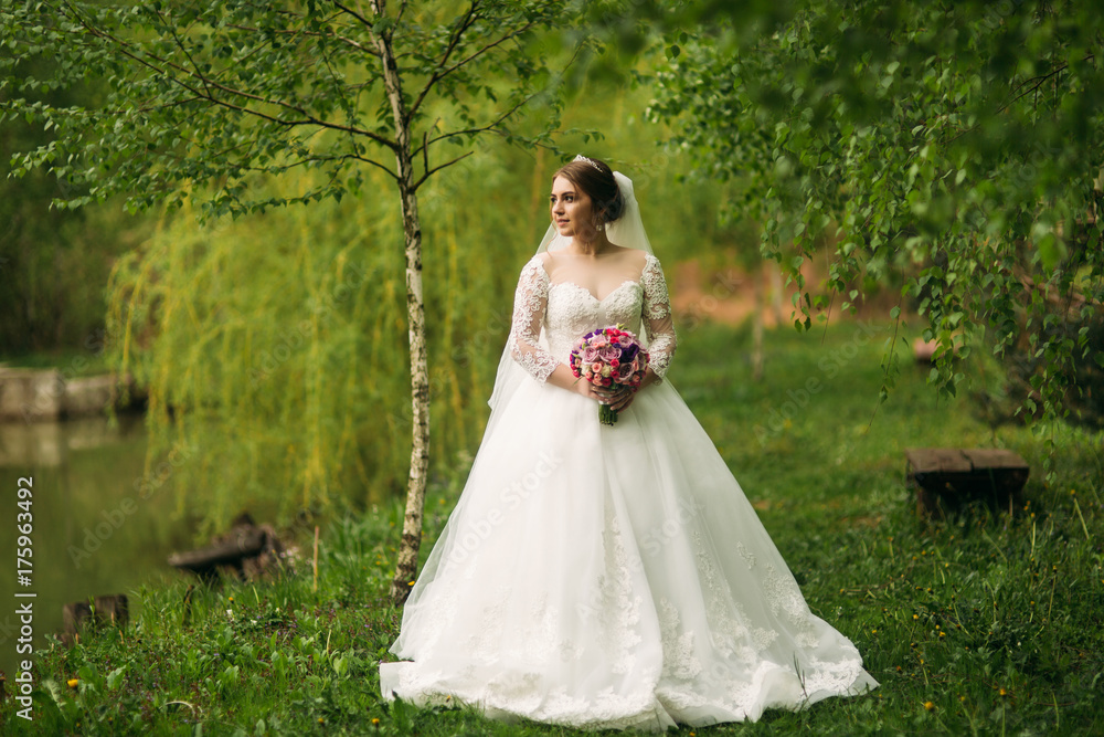 Beautiful couple walking in the park in their wedding day