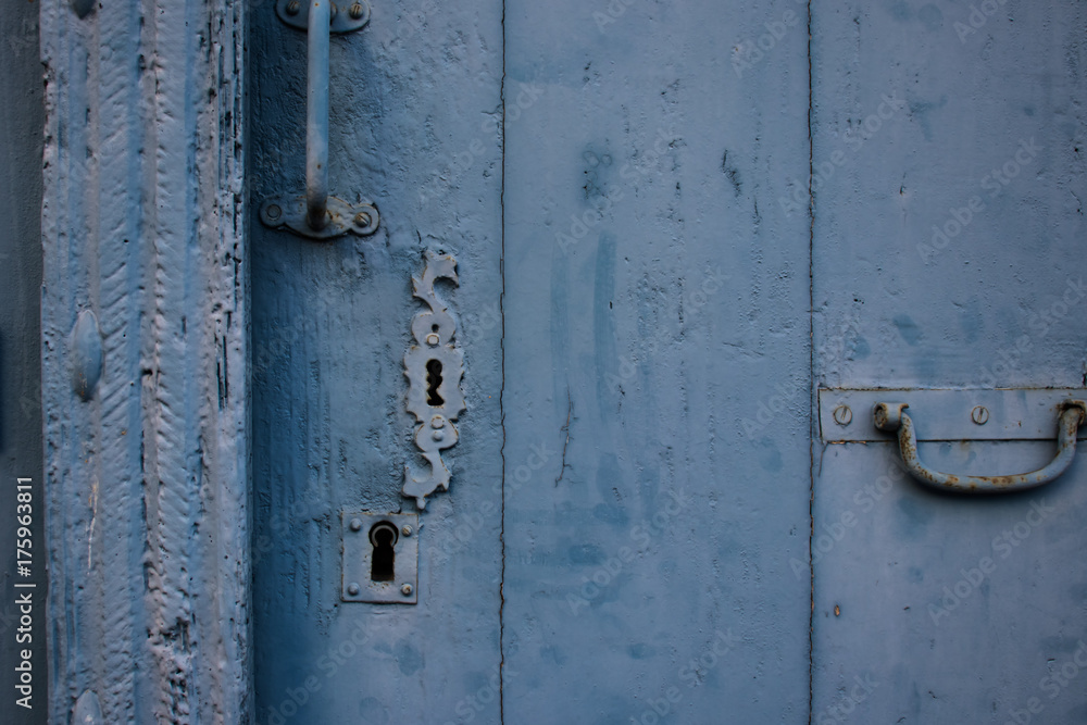 Closed catch on old blue painted door close up. Closed catch on old blue painted door close up.