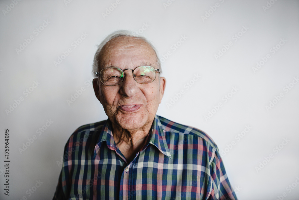 Playful senior man removing dentures and laughing Playful senior man removing dentures and laughing