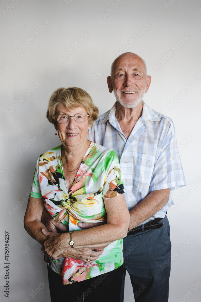 Happy senior couple looking at camera on white background Happy senior couple looking at camera on white background