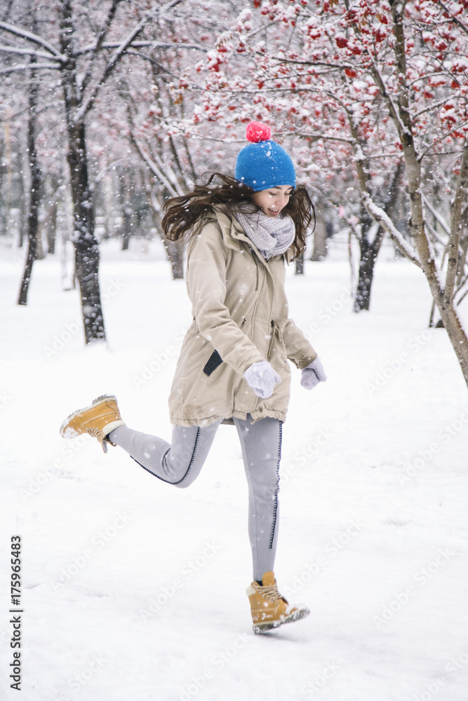 Pretty young woman running in winter park Pretty young woman running in winter park