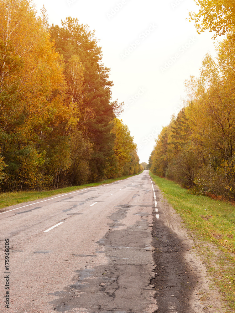Autumn road car . Terrible pavement on the road in rural areas . Russian roads