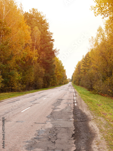 Autumn road car . Terrible pavement on the road in rural areas . Russian roads