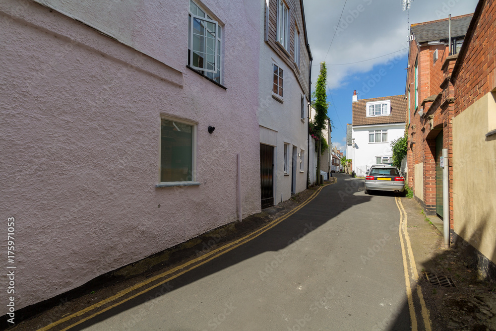 Very narrow street in Topsham. A car is parked on the road. Devon. UK