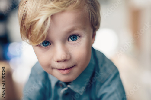 Curious young boy with big blue eyes