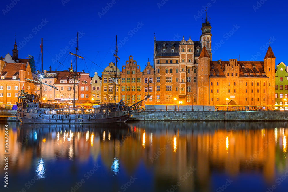 Old town of Gdansk at night reflected in Motlawa river, Poland