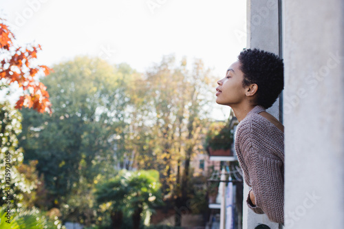 Woman with closed eyes breathing fresh air photo