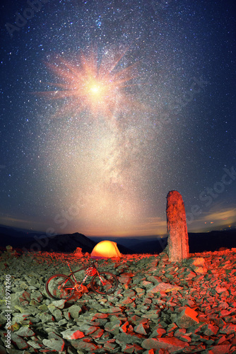 bike on a stone pillar tops at night photo