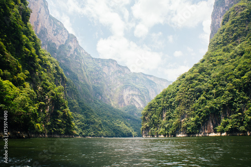 Scenic valley view of canyon and lake surrounded by vegetation in Chiapas, Mexico. photo