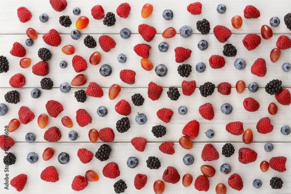 Assorted berries on white wooden table top view Assorted berries on white wooden table top view