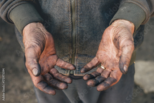 Worker showing his dirty hands