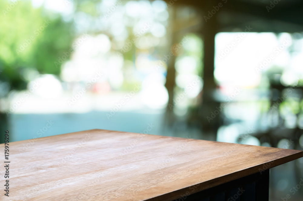 empty wood table in front of blurred montage home garden background