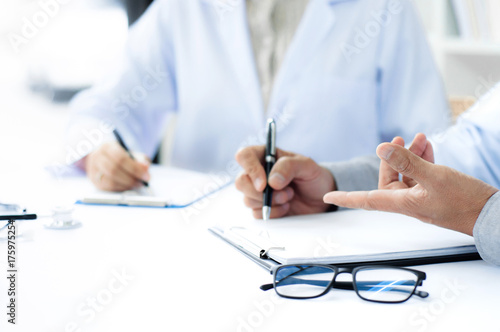 Doctor giving advice with partner about the diagnosis at a hospital