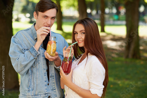 Healthy nutrition. Couple drinking fresh juice detox tea. Young friends lifestyle, vegetarian diet, fitness food on the go, weight loss together concept