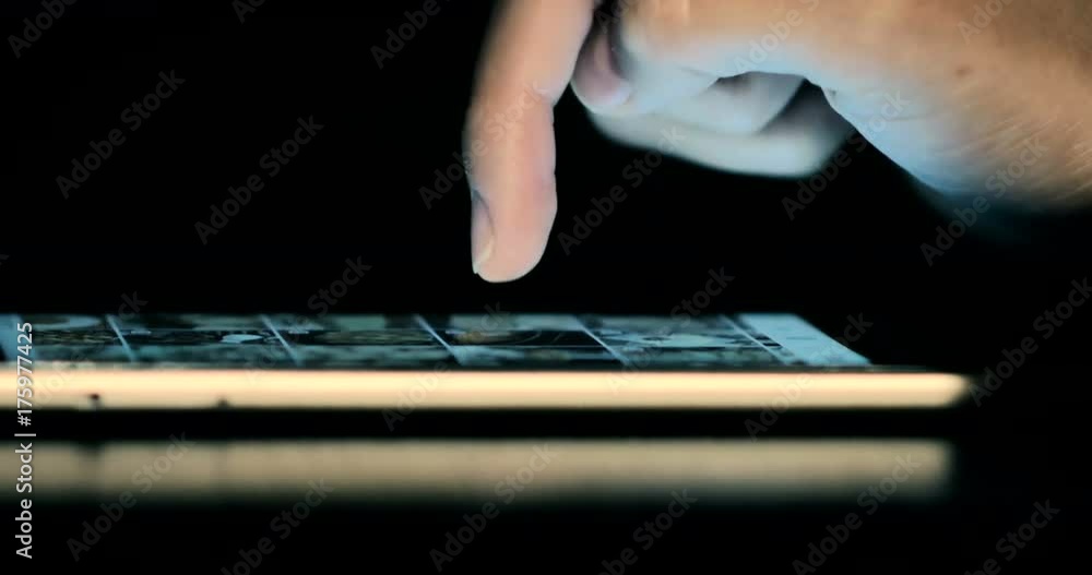 Dolly close-up of a young girl communicates in Instagram on smart-phone on the dark. Dolly close-up of a young girl communicates in Instagram on smart-phone on the dark.