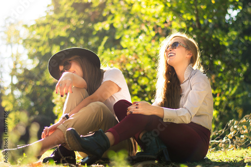 Two friends enjoying autumn day in the park