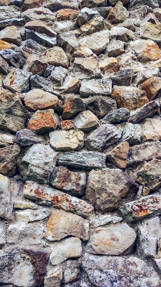 Stone old wall from huge blocks. Background of stones. The concept of reliability. Beautiful textured vintage antique background. Stone old wall from huge blocks. Background of stones. The concept of reliability. Beautiful textured vintage antique background.