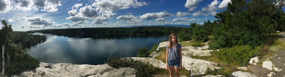Teenage girl standing by lake. 